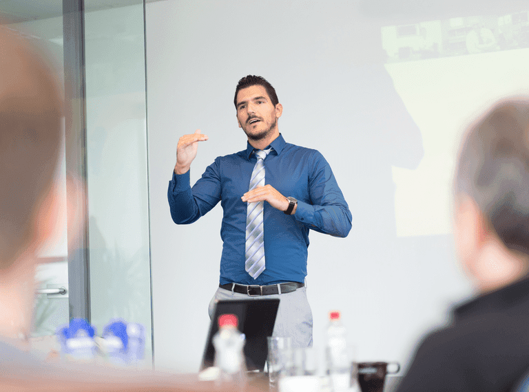 A man confidently gives an interview presentation.