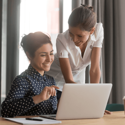 Two women using a laptop