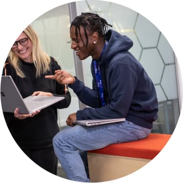 Two people looking at a laptop