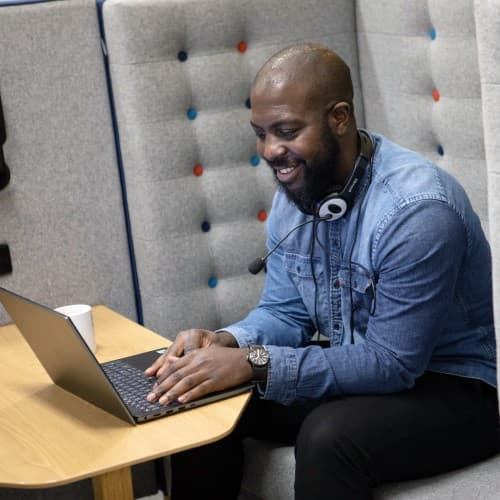 Man on laptop with headphones