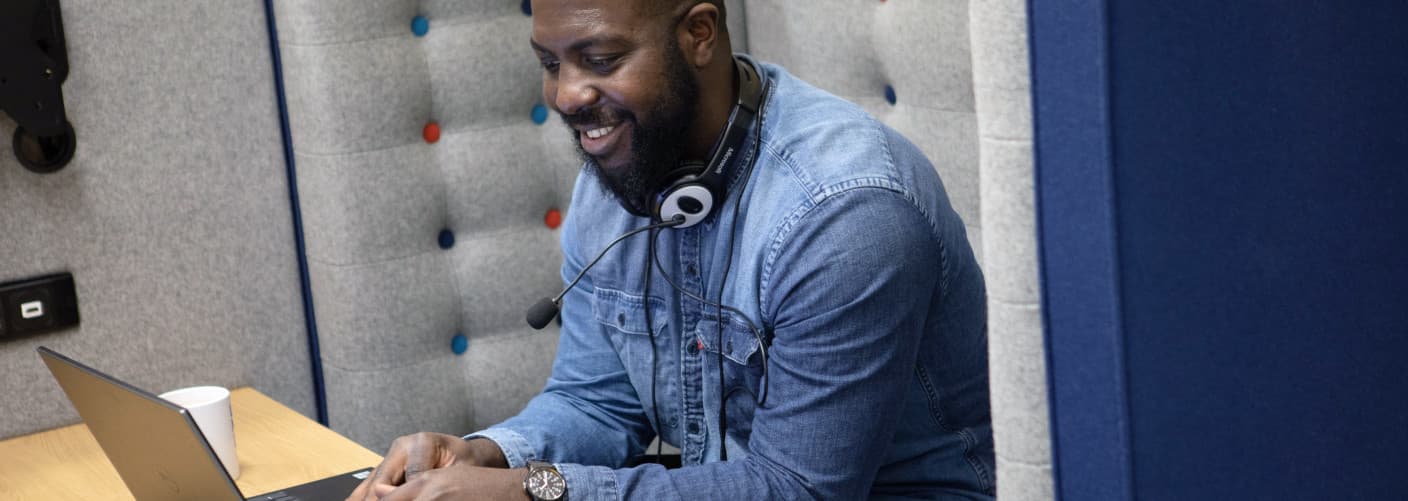 Man on a laptop with a headset